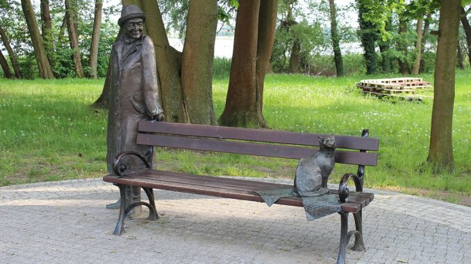 Standbeeld van Wisława Szymborska met kat op een bank in Kórnik, Polen