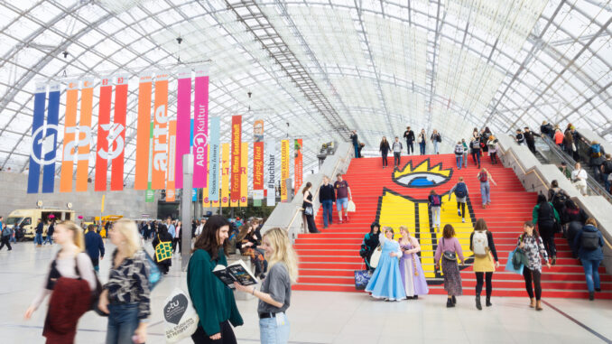 Bezoekers op de iconische rode trap van de Leipziger Buchmesse op het terrein van Messe Leipzig