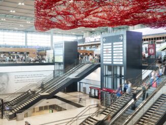 Binnenruimte van Terminal 1 op luchthaven BER in Berlijn met roltrappen en reizigers